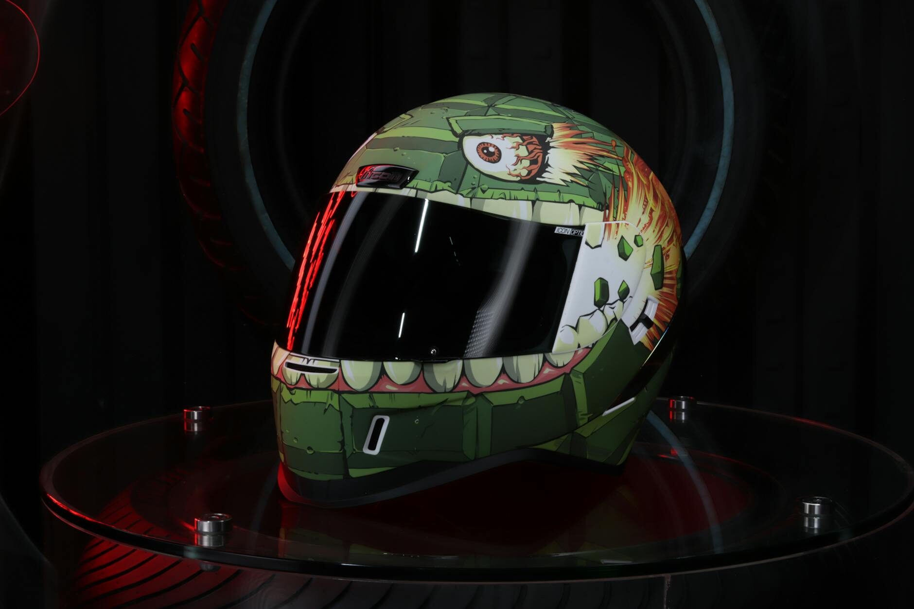 Custom airbrush-painted motorcycle helmet with detailed character artwork on a dark display stand